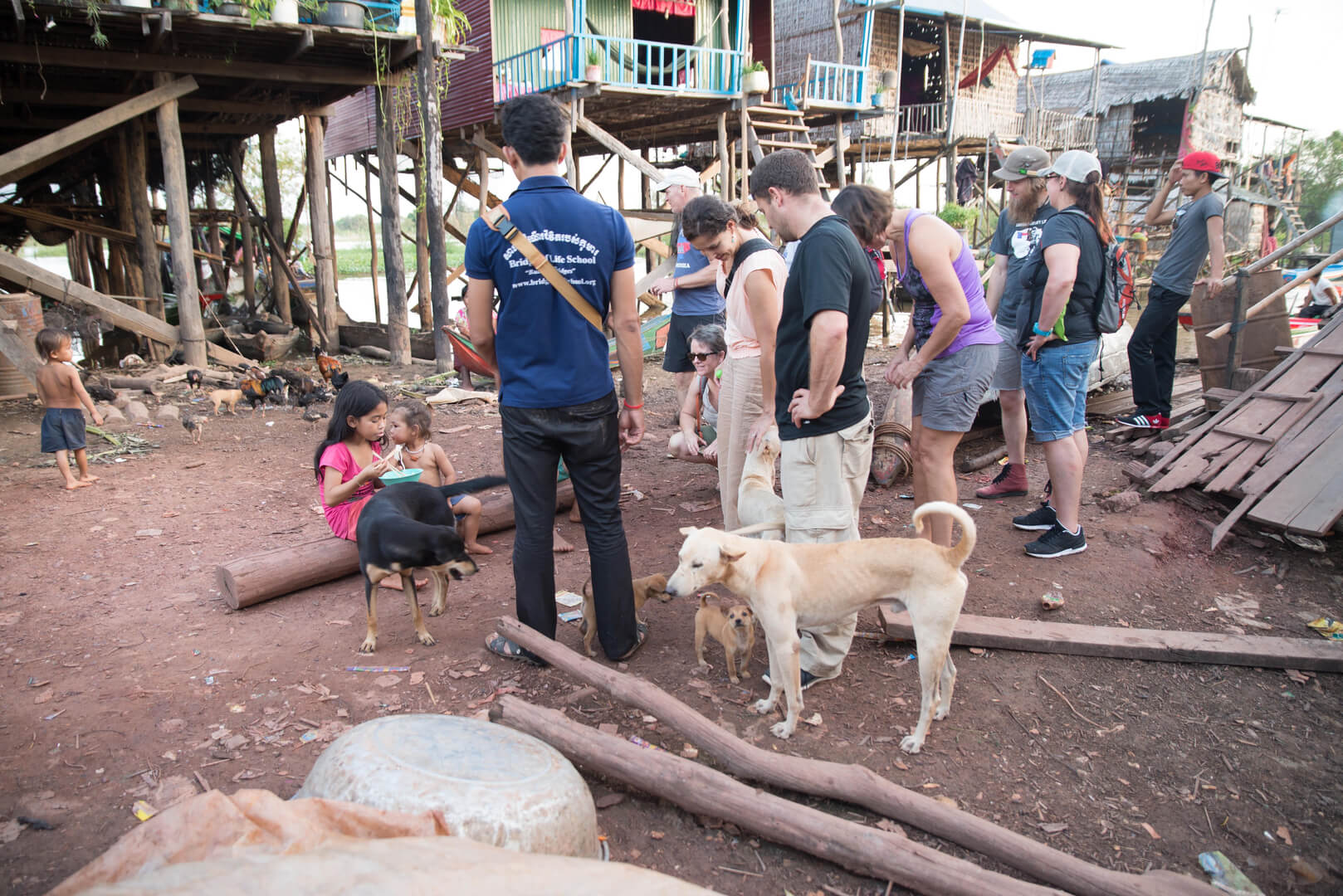 A group of people standing around with dogs.