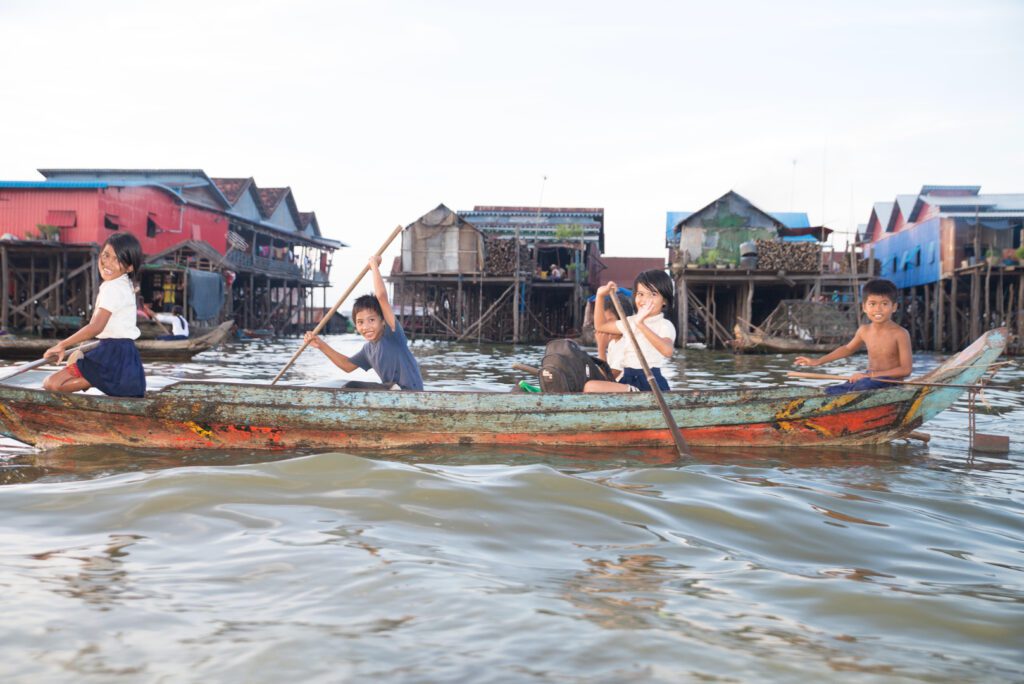 Two people are rowing a boat in the water.