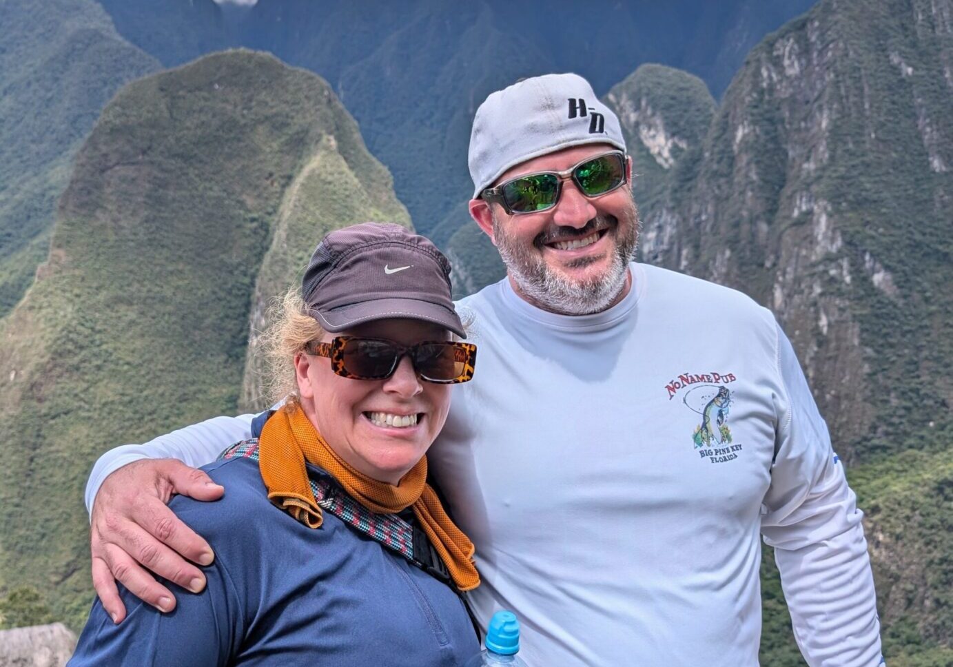 Two hikers embracing in mountain scenery